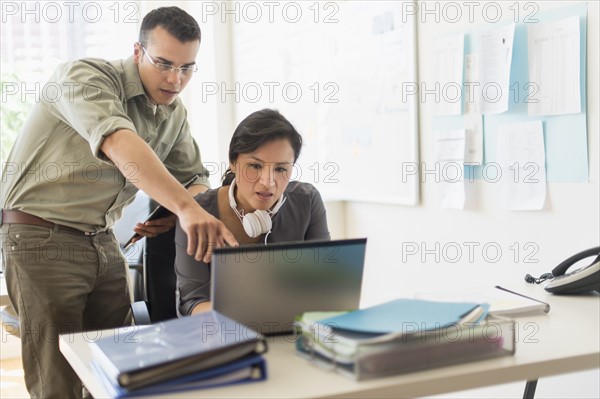 Two people working together with laptop.