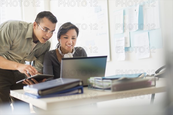 Two people working together with laptop.