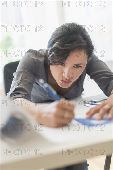 Woman drawing blueprints.