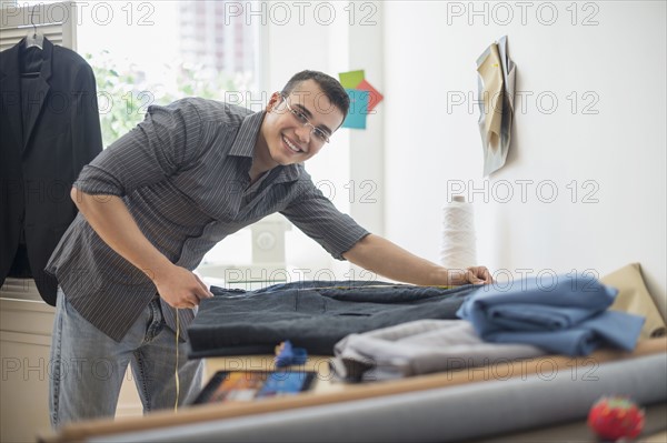 Fashion designer measuring vest.