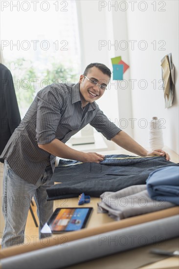 Fashion designer measuring vest.