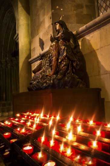 Candles in front of Virgin Mary statue in Monastery of Jeronimos. Lisbon, Portugal.
