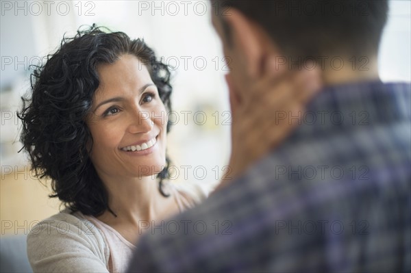 Woman touching man's neck.