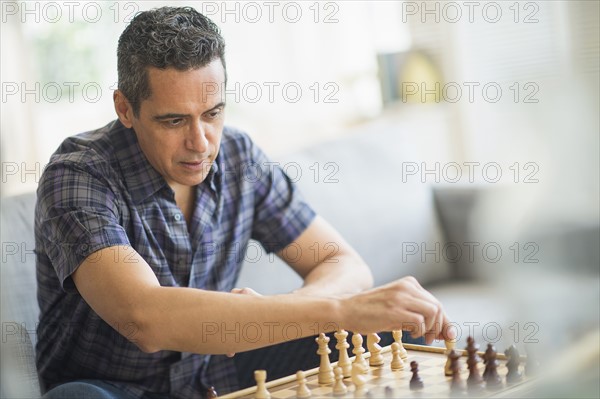 Mature man playing chess.