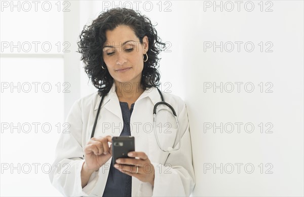 Female doctor using cell phone.
