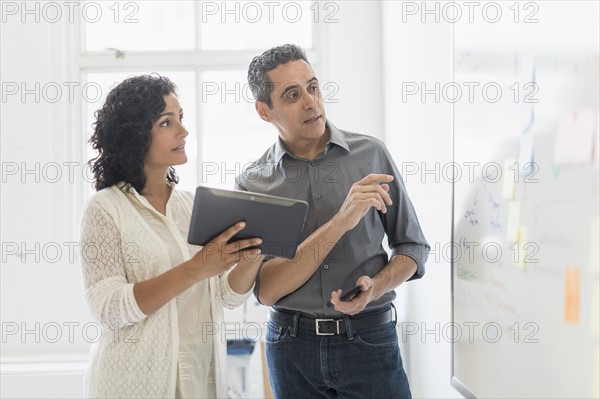 Man and woman working together in office.