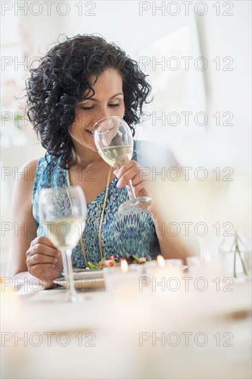 Woman tasting wine in restaurant.