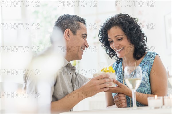 Couple celebrating anniversary in restaurant.