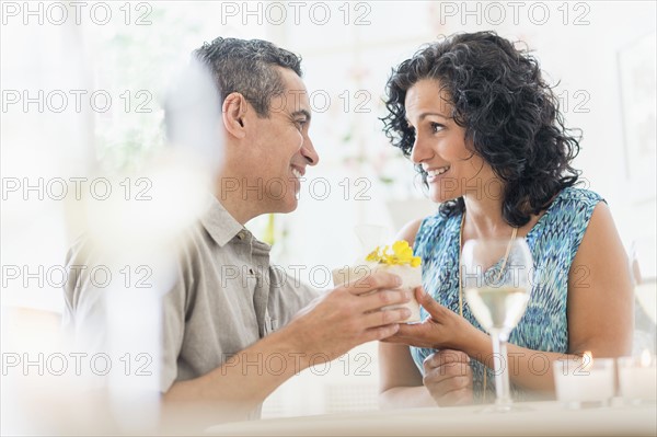 Couple celebrating anniversary in restaurant.