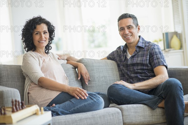 Couple sitting on sofa.