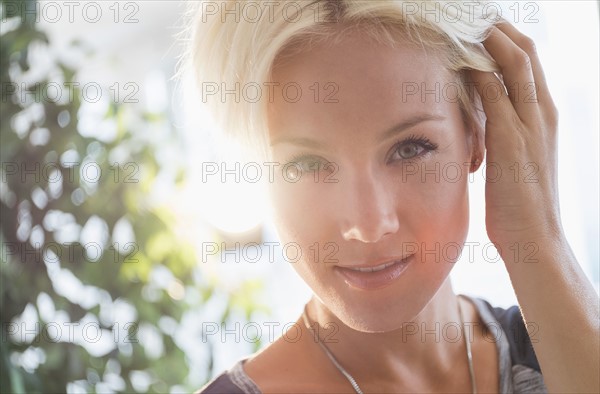 Portrait of happy blonde woman smiling.