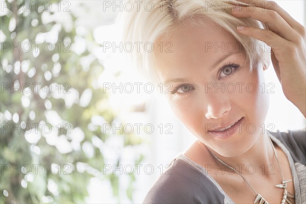 Portrait of happy blonde woman smiling.