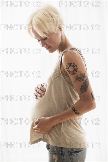 Pregnant woman with hands on stomach.