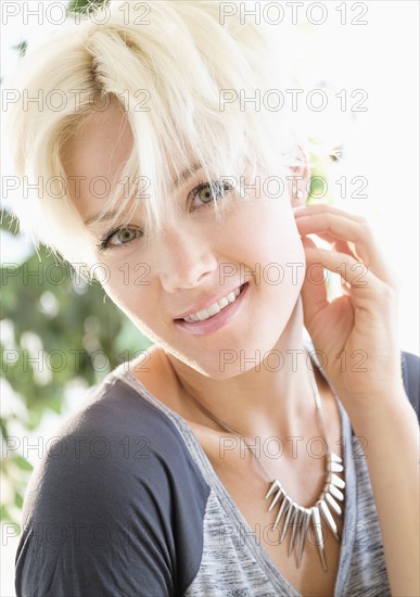 Portrait of blonde woman wearing necklace.