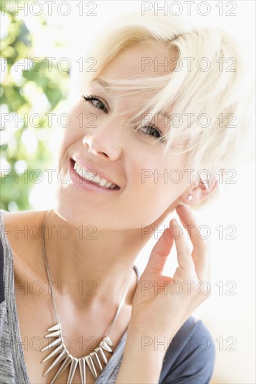 Portrait of blonde woman wearing necklace.