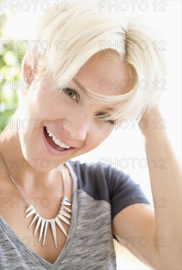 Portrait of blonde woman wearing necklace.