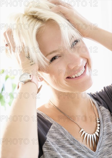Portrait of blonde woman wearing necklace.