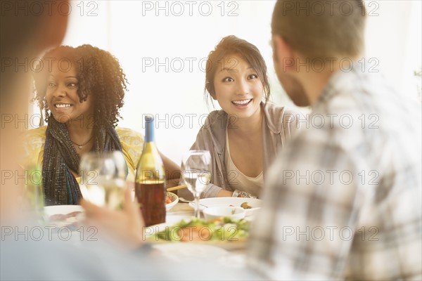 Group of friends enjoying dinner party.