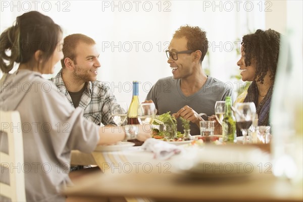 Group of friends enjoying dinner party.