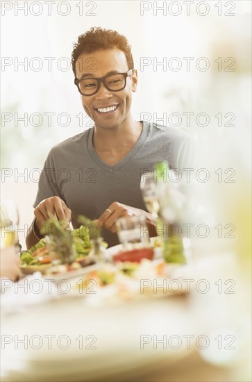 Young man enjoying dinner party.