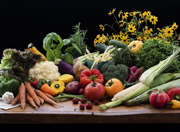 Still life with various vegetables and flowers.