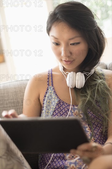 Young woman using digital tablet at home.