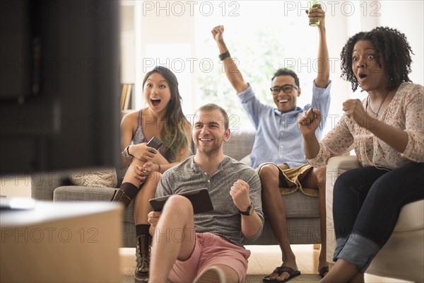 Group of friends watching television.