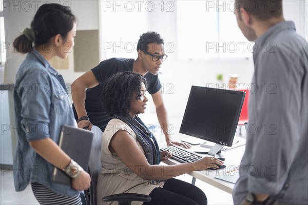 Women and men working in office.