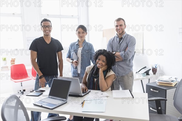 Women and men working in office.