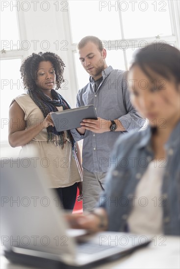 Man and women working in office.