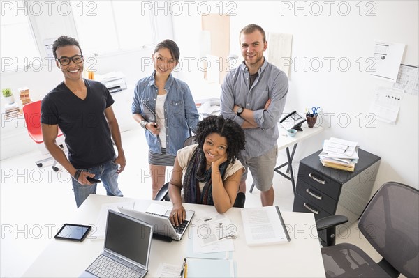 Women and men working in office.