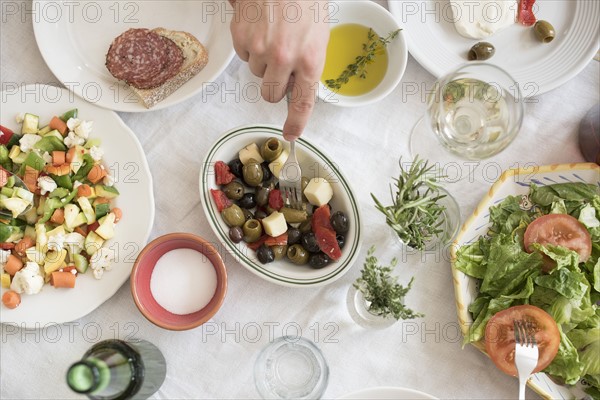 Hand serving salad.