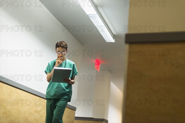 Female doctor in hospital corridor.