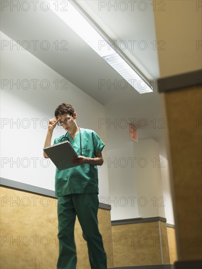 Female doctor in hospital corridor.