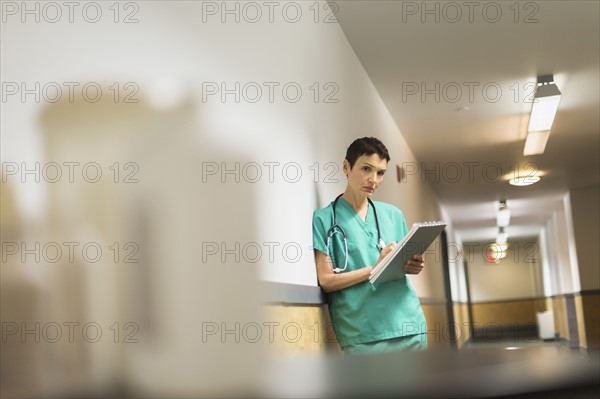 Female doctor in hospital corridor.