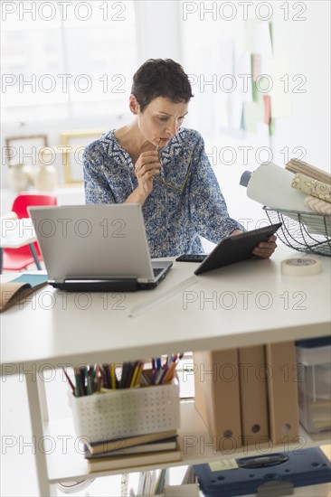 Senior business woman using tablet pc in office.