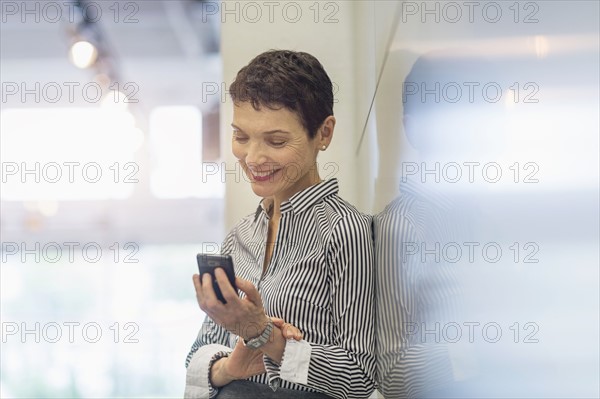 Businesswoman using smartphone.