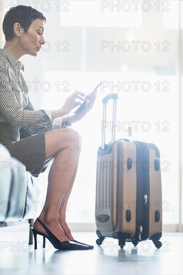 Businesswoman at the airport using tablet.