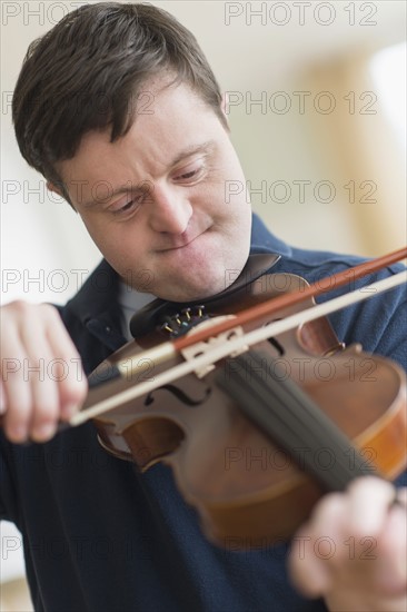 Man with down syndrome playing violin.