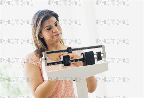 Woman standing on scale.