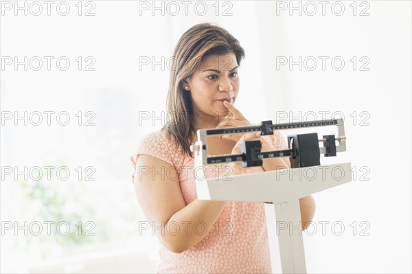 Woman standing on scale.