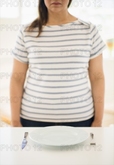 Woman standing by table.