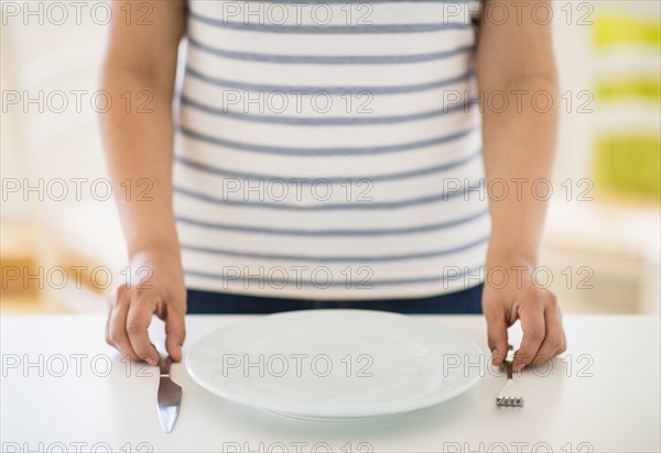 Woman standing by table.