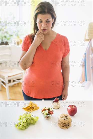 Woman standing by counter in kitchen.