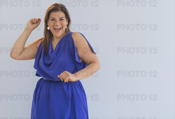 Studio shot of happy woman.