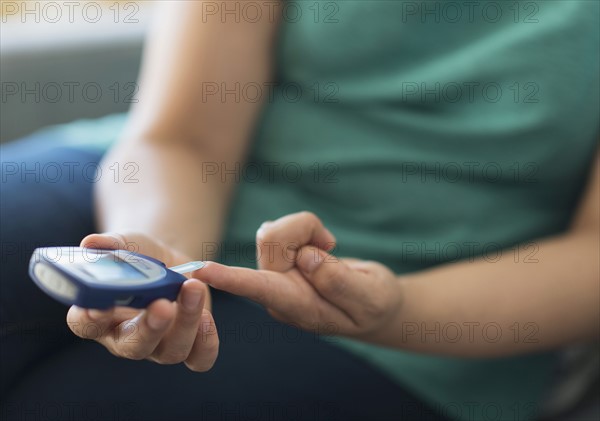 Woman sitting on sofa with mobile phone.