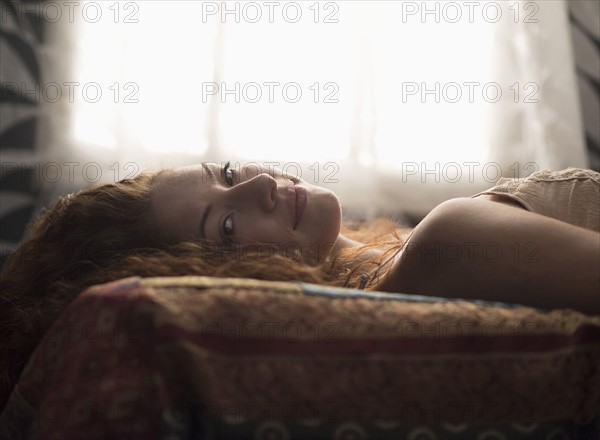 Portrait of stylish woman in bed.