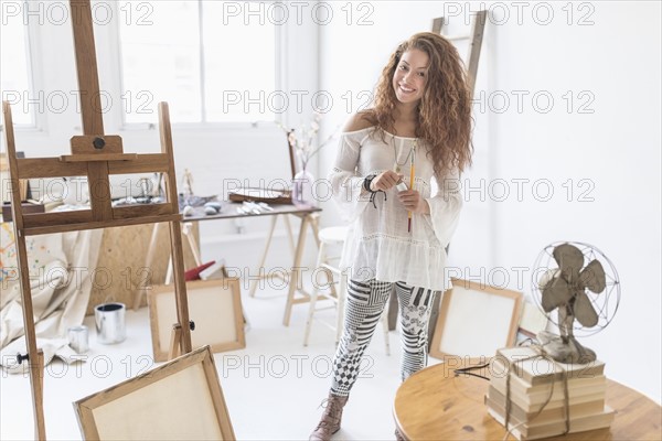 Young female artist in studio.