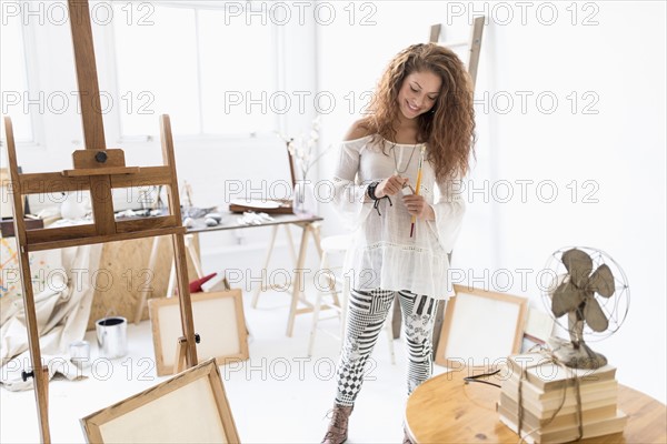 Young female artist in studio.