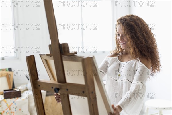 Young female artist in studio.